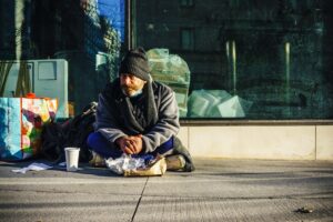 Homeless person sitting on the street