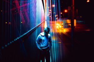 Teenager walking on bridge at night